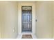 Front door with welcome mat and sidelight providing natural light to the foyer at 6646 Sw 64Th Ave, Ocala, FL 34476