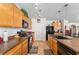 Functional kitchen with dark appliances, wood cabinetry, and center island for meal prep at 6646 Sw 64Th Ave, Ocala, FL 34476