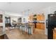 Bright eat-in kitchen with center island, pendant lighting, and black appliances at 6646 Sw 64Th Ave, Ocala, FL 34476