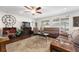 Cozy living room featuring a fireplace, ceiling fan, and windows to let the light stream in at 6646 Sw 64Th Ave, Ocala, FL 34476