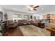 Spacious living room boasts hardwood floors, a ceiling fan, and large windows for natural light at 6646 Sw 64Th Ave, Ocala, FL 34476