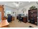 Bright office with two desks, ceiling fan, carpeting, and large bookshelf; ready for work or study at 6646 Sw 64Th Ave, Ocala, FL 34476