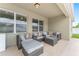 Comfortable outdoor patio featuring modern seating with plush cushions, perfect for relaxing and entertaining under a covered space at 6646 Sw 64Th Ave, Ocala, FL 34476