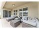 Cozy outdoor patio with stylish seating, including a sofa, ottoman, and coffee table, ideal for outdoor gatherings at 6646 Sw 64Th Ave, Ocala, FL 34476
