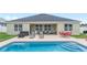 The backyard features a pool with lounge chairs and outdoor seating next to the home at 6646 Sw 64Th Ave, Ocala, FL 34476