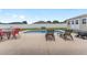 Backyard pool with lounge chairs, table, and fire pit, perfect for outdoor entertaining at 6646 Sw 64Th Ave, Ocala, FL 34476