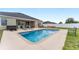 A backyard features a pool and patio seating area next to the home and a hot tub at 6646 Sw 64Th Ave, Ocala, FL 34476