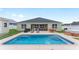 The backyard features a pool, lounge chairs, and patio seating next to the home at 6646 Sw 64Th Ave, Ocala, FL 34476