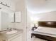 Bathroom and bedroom featuring a granite counter, mirror and medicine cabinet at 70 Sapphire Rd, Ocala, FL 34472