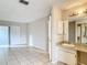 Bedroom and bathroom area with sliding glass doors and granite vanity at 70 Sapphire Rd, Ocala, FL 34472