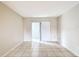 A bedroom with neutral walls, tile flooring, and sliding glass door to sunroom at 70 Sapphire Rd, Ocala, FL 34472