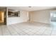 Spacious living room with tile flooring and an open view to the kitchen with wooden cabinets at 70 Sapphire Rd, Ocala, FL 34472