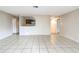 Bright living room with a glimpse into the kitchen, featuring tile floors and neutral paint at 70 Sapphire Rd, Ocala, FL 34472