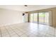 Expansive living room boasts tile floors and sliding glass doors that open to the backyard at 70 Sapphire Rd, Ocala, FL 34472
