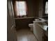 Bathroom featuring a toilet, vanity and window at 7802 Sw 114Th Loop, Ocala, FL 34476