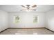 Bright bedroom featuring tiled floors, two windows and ceiling fan with light at 8205 Sw 100Th Lane Rd, Ocala, FL 34481