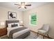 Comfortable bedroom featuring a neutral color scheme, ceiling fan, and ample natural light at 8205 Sw 100Th Lane Rd, Ocala, FL 34481