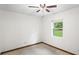 A quaint bedroom featuring tile floors, a ceiling fan, and a window with a view of the backyard at 8205 Sw 100Th Lane Rd, Ocala, FL 34481