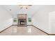 A bright living room featuring a brick fireplace, tiled floor and natural light from two windows at 8205 Sw 100Th Lane Rd, Ocala, FL 34481