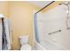 Bathroom with standard toilet and tub/shower combination with white tile and a shower curtain at 8554 Sw 63Rd Ct, Ocala, FL 34476