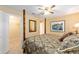 Bedroom featuring a decorative four-poster bed, ceiling fan, and access to a walk-in closet at 8554 Sw 63Rd Ct, Ocala, FL 34476