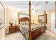 Spacious bedroom featuring a wooden four-poster bed, neutral walls, and plush carpeting for a cozy retreat at 8554 Sw 63Rd Ct, Ocala, FL 34476