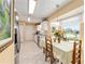 Charming breakfast area bathed in natural light, featuring tiled floors and views of the lush exterior at 8554 Sw 63Rd Ct, Ocala, FL 34476