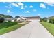 Beautiful front view of house with green grass and a concrete driveway on a sunny day with blue skies at 8554 Sw 63Rd Ct, Ocala, FL 34476