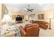 Spacious living area featuring neutral carpet, vaulted ceiling, ceiling fan, and comfortable furniture at 8554 Sw 63Rd Ct, Ocala, FL 34476