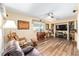 The living room has hardwood floors, a ceiling fan, a TV, and leather furniture at 8554 Sw 63Rd Ct, Ocala, FL 34476