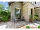 Charming front porch with chairs, table and green accents and stone exterior at 9158 Sw 65Th Loop, Ocala, FL 34481