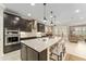 Gourmet kitchen with a spacious island, dark cabinets, modern appliances, and an open concept design at 9158 Sw 65Th Loop, Ocala, FL 34481