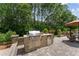 This outdoor kitchen features stainless steel grill, granite countertops and a seating area for entertaining at 9158 Sw 65Th Loop, Ocala, FL 34481