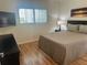 This bedroom features a large window, mounted TV, and neutral decor at 9255 Sw 90Th Ct # B, Ocala, FL 34481