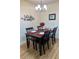 Dining area features a dark wood table with seating for four and a modern chandelier at 9255 Sw 90Th Ct # B, Ocala, FL 34481