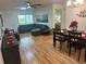 Open-concept living and dining area with lots of natural light and a modern sectional sofa at 9255 Sw 90Th Ct # B, Ocala, FL 34481