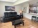 Comfortable living room with black leather reclining sofa and open access to kitchen at 9255 Sw 90Th Ct # B, Ocala, FL 34481
