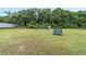 Large backyard area featuring a playground, trampoline, and plenty of grassy space for activities and play at 9420 Ne 12Th Ct, Ocala, FL 34479