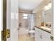 Bathroom features a tiled shower over tub combo and a single sink vanity at 9420 Ne 12Th Ct, Ocala, FL 34479