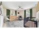 Well-lit Bedroom featuring a crib, dresser, and a stylish patterned rug at 9420 Ne 12Th Ct, Ocala, FL 34479