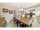 Cozy dining room adjacent to the kitchen, featuring a rustic table with black chairs at 9420 Ne 12Th Ct, Ocala, FL 34479
