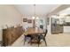 Bright dining area with a rustic wooden table and views into the kitchen at 9420 Ne 12Th Ct, Ocala, FL 34479