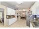 Bright open kitchen leading to the dining room and featuring stainless appliances and granite counters at 9420 Ne 12Th Ct, Ocala, FL 34479