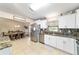 Spacious kitchen featuring stainless steel appliances and adjacent dining area at 9420 Ne 12Th Ct, Ocala, FL 34479