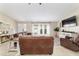 Inviting living room with a large brown leather sofa, white trim, and lots of natural light at 9420 Ne 12Th Ct, Ocala, FL 34479