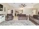 Spacious living area featuring neutral walls, tile flooring, and a view into the dining area at 9420 Ne 12Th Ct, Ocala, FL 34479