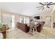 Inviting living room featuring tile flooring, with cozy sofas and natural light creating a welcoming atmosphere at 9420 Ne 12Th Ct, Ocala, FL 34479