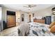 Spacious main bedroom with a ceiling fan, neutral walls, and well-placed decor at 9420 Ne 12Th Ct, Ocala, FL 34479