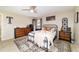 Comfortable main bedroom with neutral tones, ceiling fan, and coordinating furnishings at 9420 Ne 12Th Ct, Ocala, FL 34479
