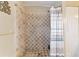 Tiled shower with mosaic tile accents and shower curtain at 9420 Ne 12Th Ct, Ocala, FL 34479